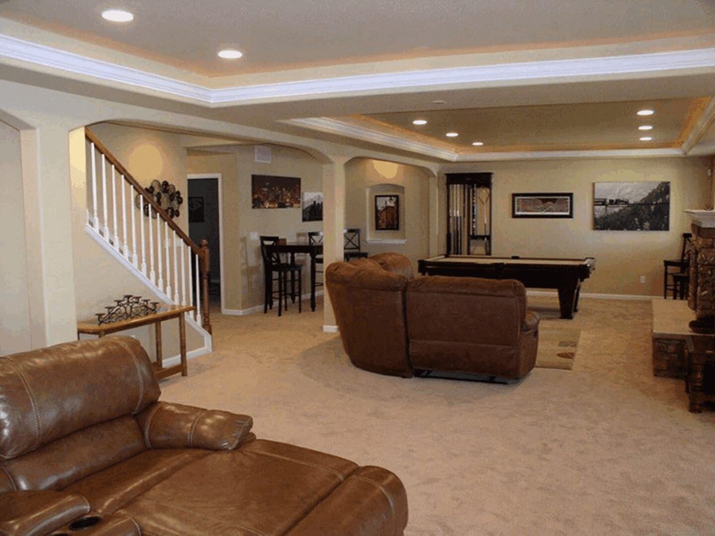 Modern basement with pool table and seating